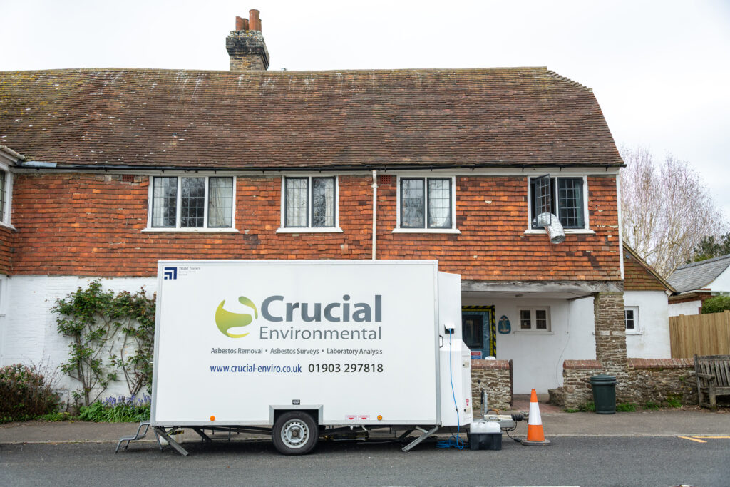 Crucial Environmental welfare unit parked outside a brick-and-tile house